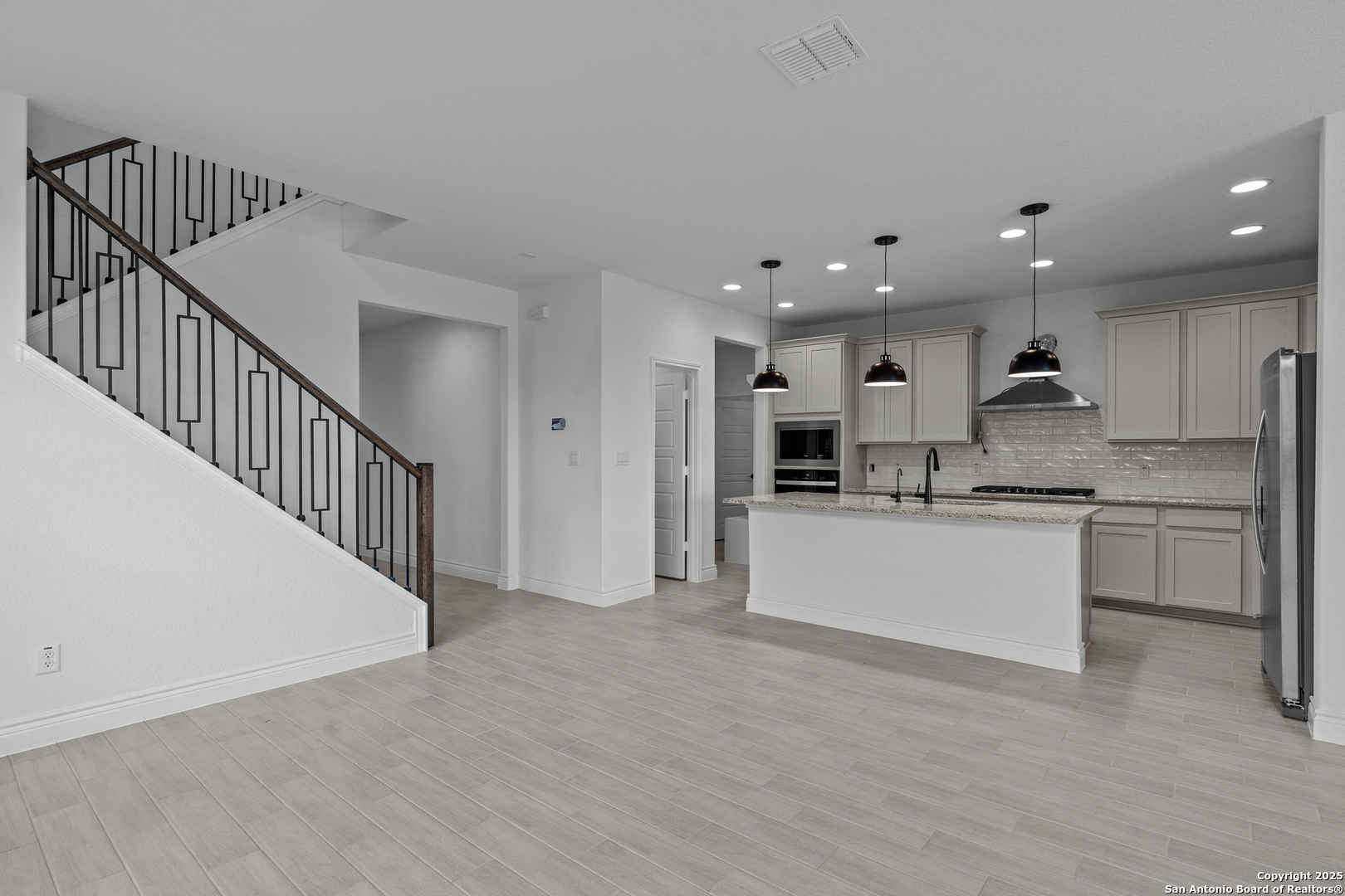 4044 Paddock Trail Seguin, TX 78155 - Photo 16 of 37 a view of kitchen with kitchen island wooden floor center island and stainless steel appliances