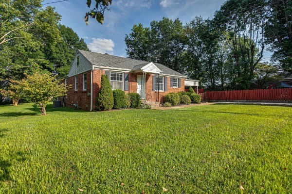 a front view of house with yard and green space
