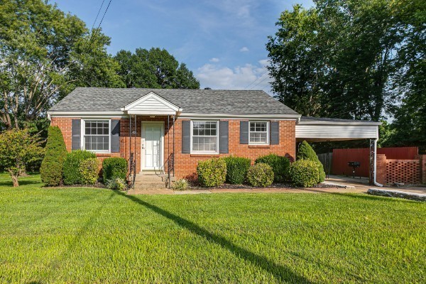 1335 Adams Street Franklin, TN 37064 - Photo 3 of 39 a front view of a house with a yard and garage