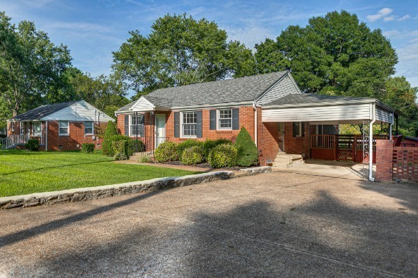 1335 Adams Street Franklin, TN 37064 - Photo 4 of 39 a front view of a house with a yard and garage