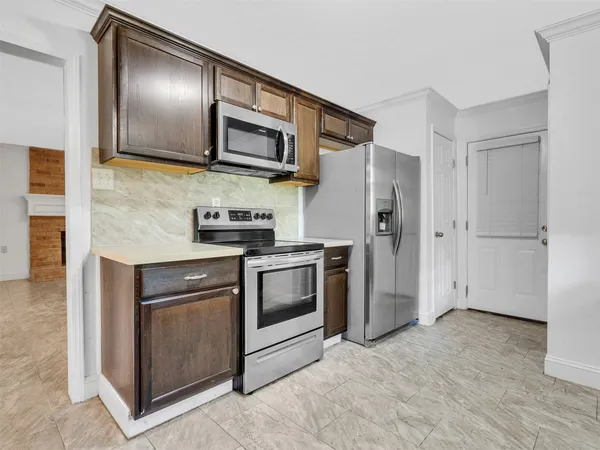 a kitchen with a sink cabinets and a window