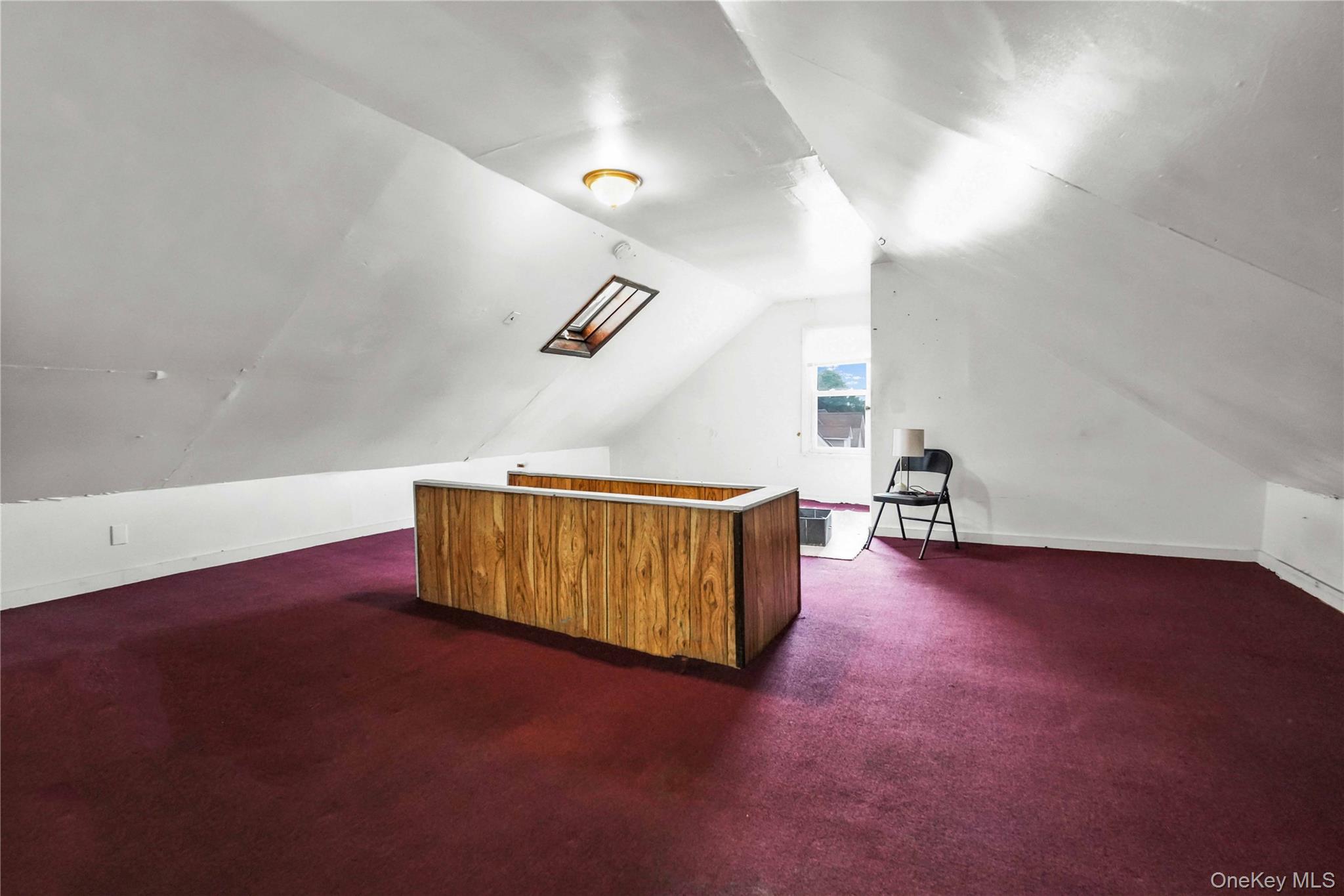 139 Spring Street Ossining, NY 10562 - Photo 20 of 29 Additional living space with dark carpet and lofted ceiling