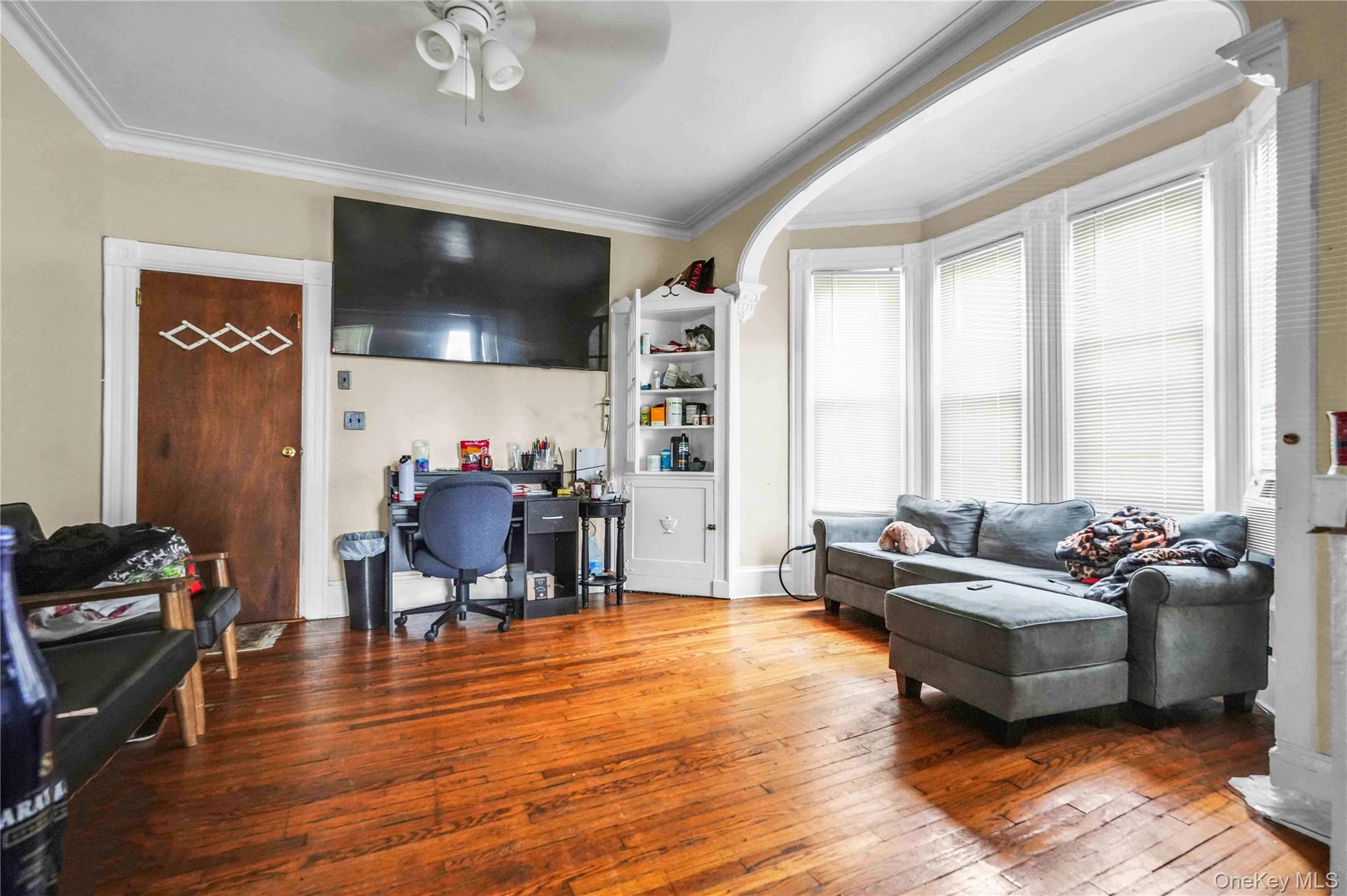 139 Spring Street Ossining, NY 10562 - Photo 4 of 29 Living area with hardwood / wood-style flooring, crown molding, ceiling fan, and a desk