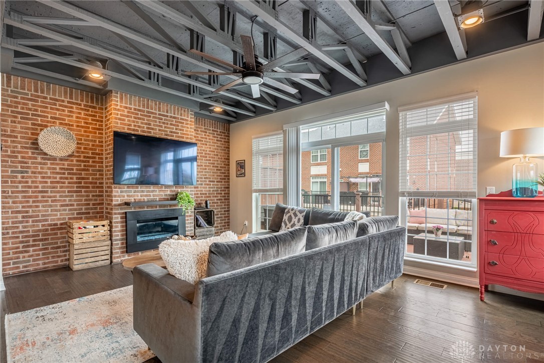 407 Brownstone Row Springboro, OH 45066 - Photo 11 of 54 This bright living space features a cozy fireplace, exposed ceiling beams, and access to an outdoor patio.