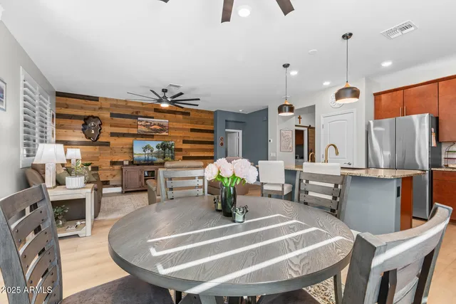 a room with stainless steel appliances furniture a rug and white walls