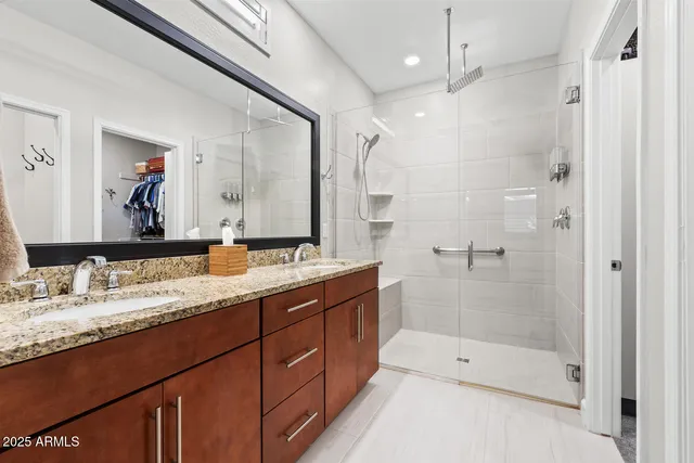 a bathroom with a granite countertop sink mirror and double