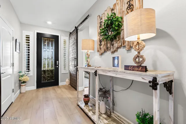 a view of a hallway with workspace and a window