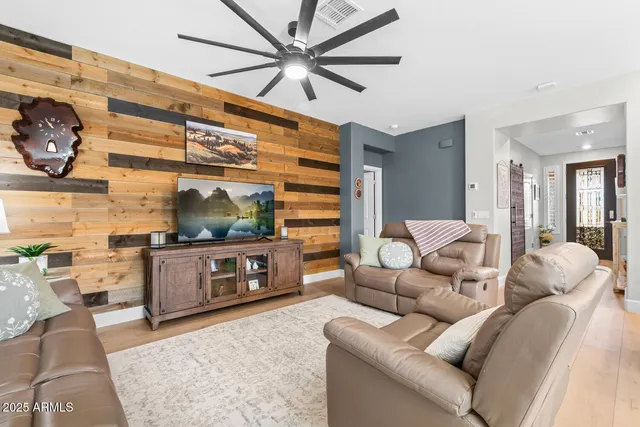 a living room with furniture and wooden floor