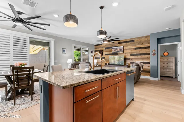 a kitchen with stainless steel appliances granite countertop a sink and a refrigerator