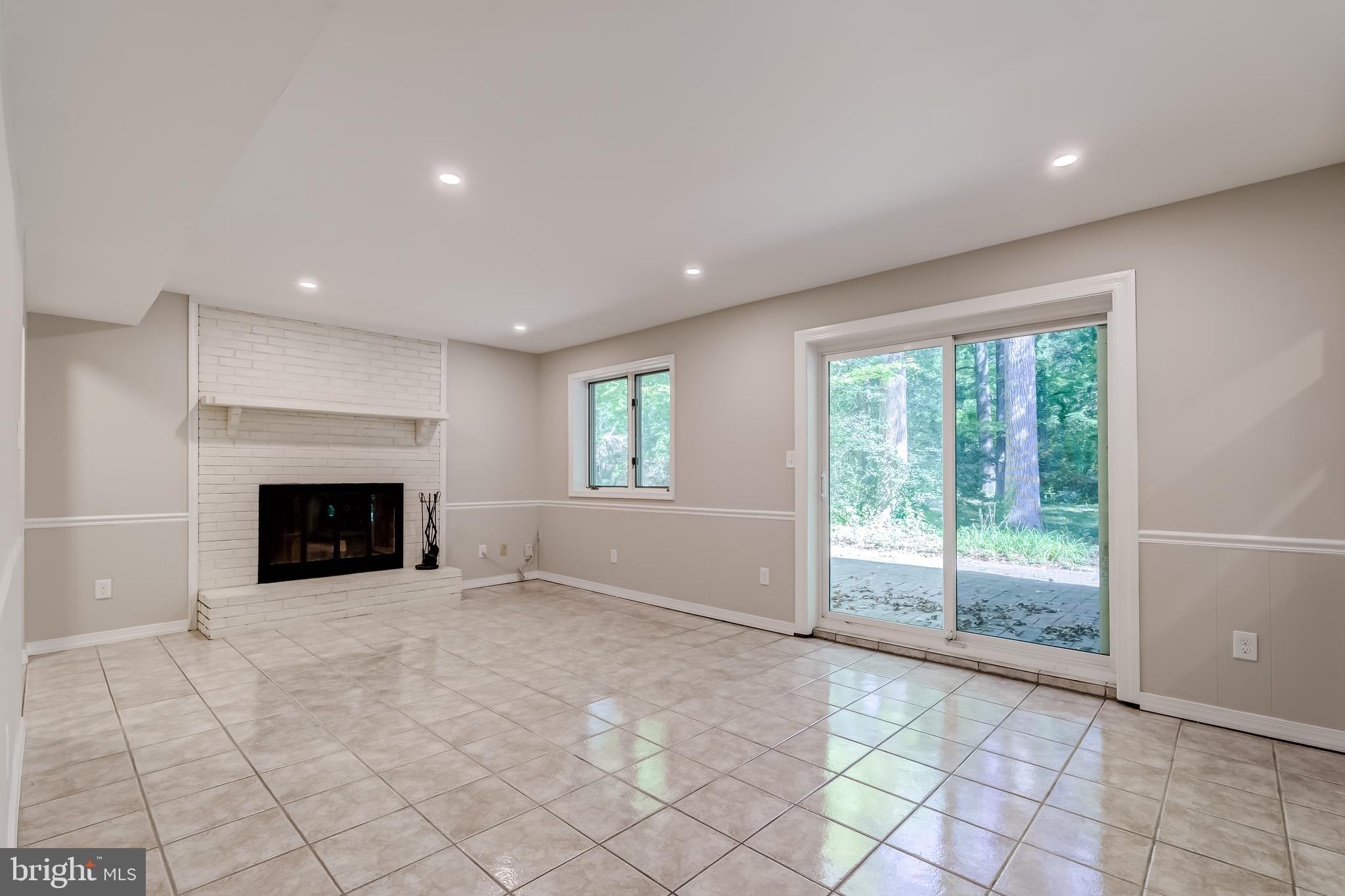 8817 Gateshead Road Alexandria, VA 22309 - Photo 14 of 78 a view of an empty room with a fireplace and a window