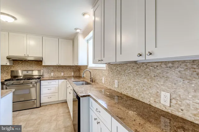 an empty room with a fireplace and windows