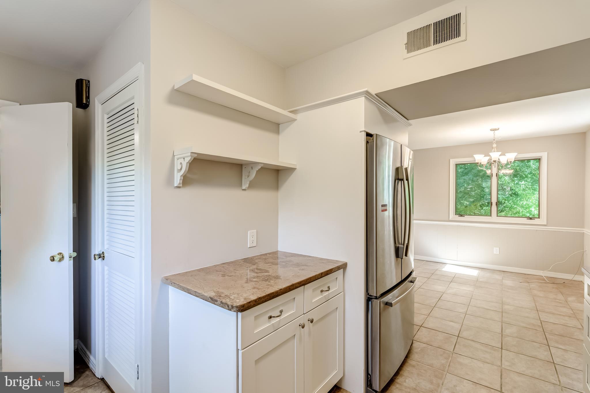 8817 Gateshead Road Alexandria, VA 22309 - Photo 20 of 78 a kitchen with a stove a refrigerator and a sink