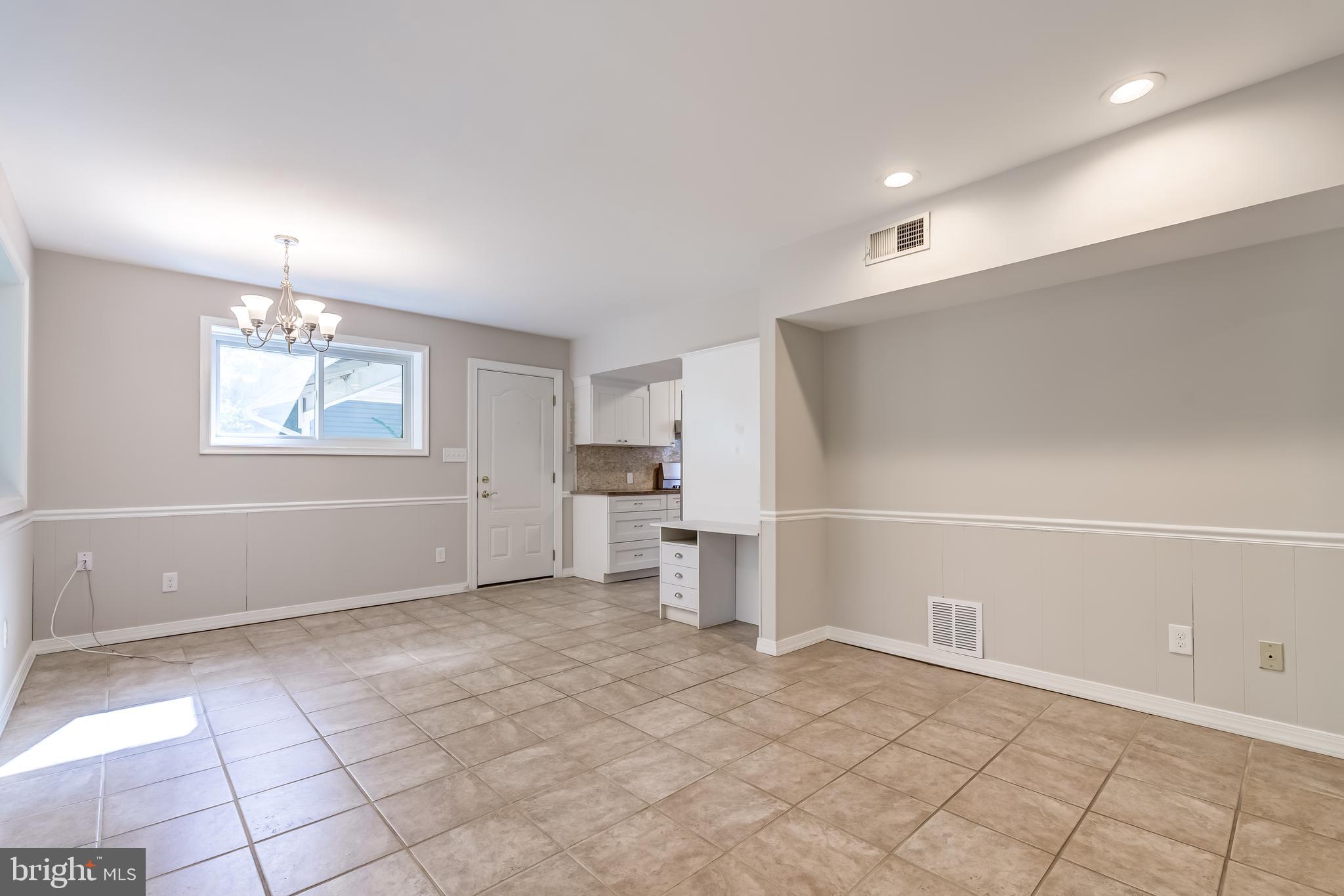 8817 Gateshead Road Alexandria, VA 22309 - Photo 26 of 78 an empty room with a fireplace and windows