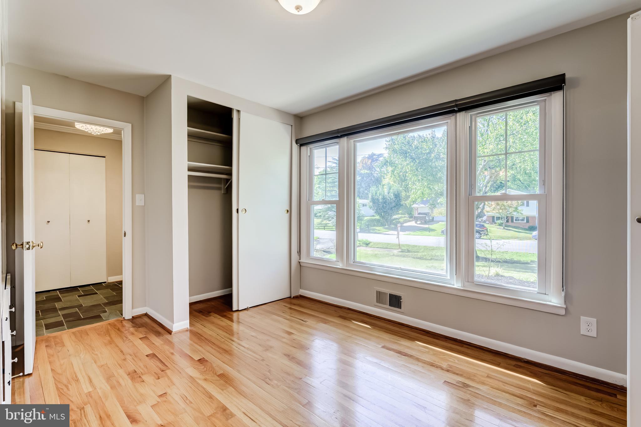 8817 Gateshead Road Alexandria, VA 22309 - Photo 29 of 78 a view of an empty room with wooden floor and a window