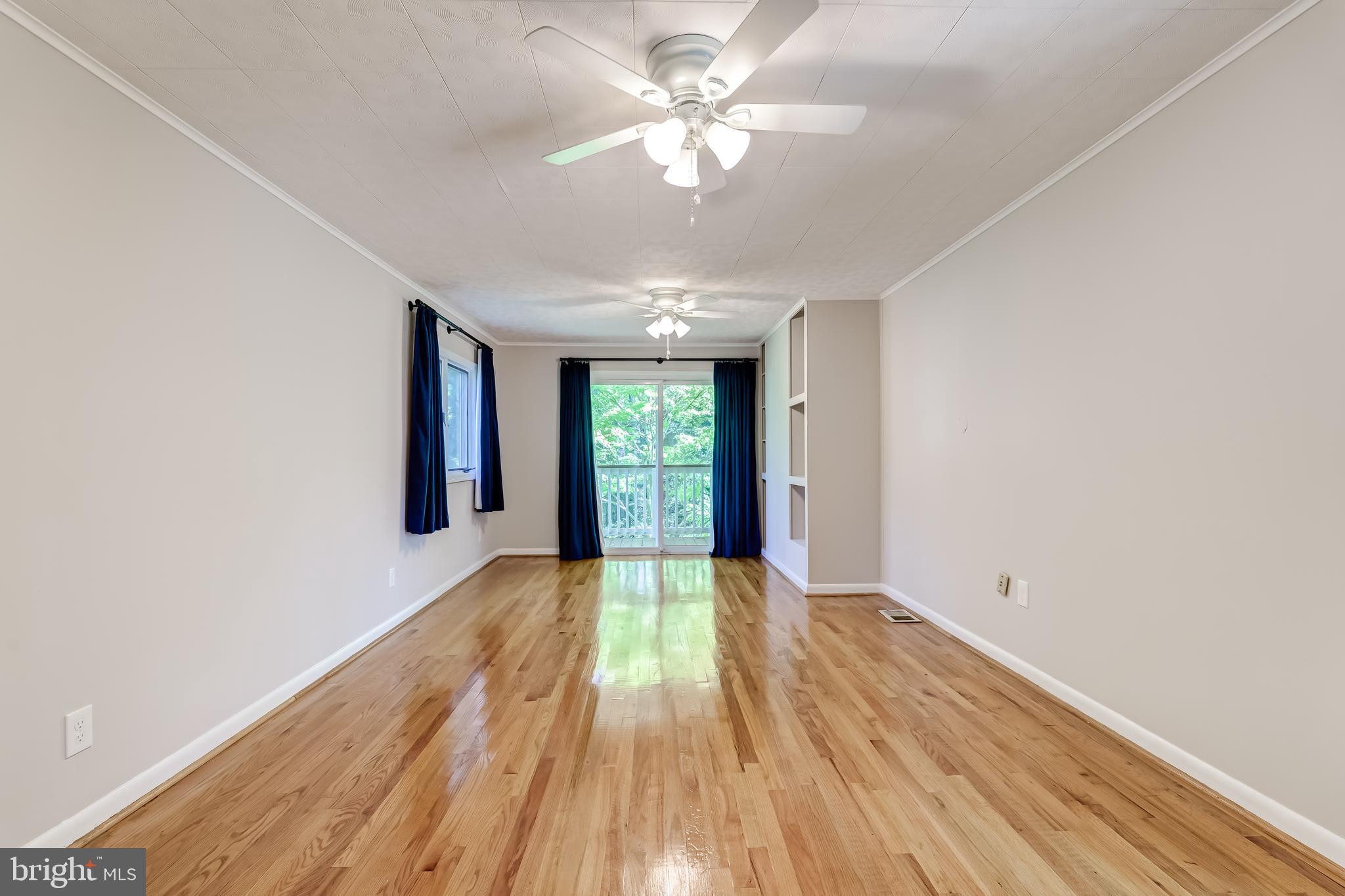 8817 Gateshead Road Alexandria, VA 22309 - Photo 30 of 78 a view of an empty room with window and wooden floor