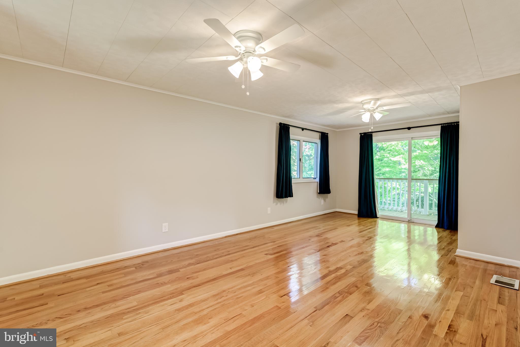 8817 Gateshead Road Alexandria, VA 22309 - Photo 35 of 78 a view of an empty room with window and wooden floor