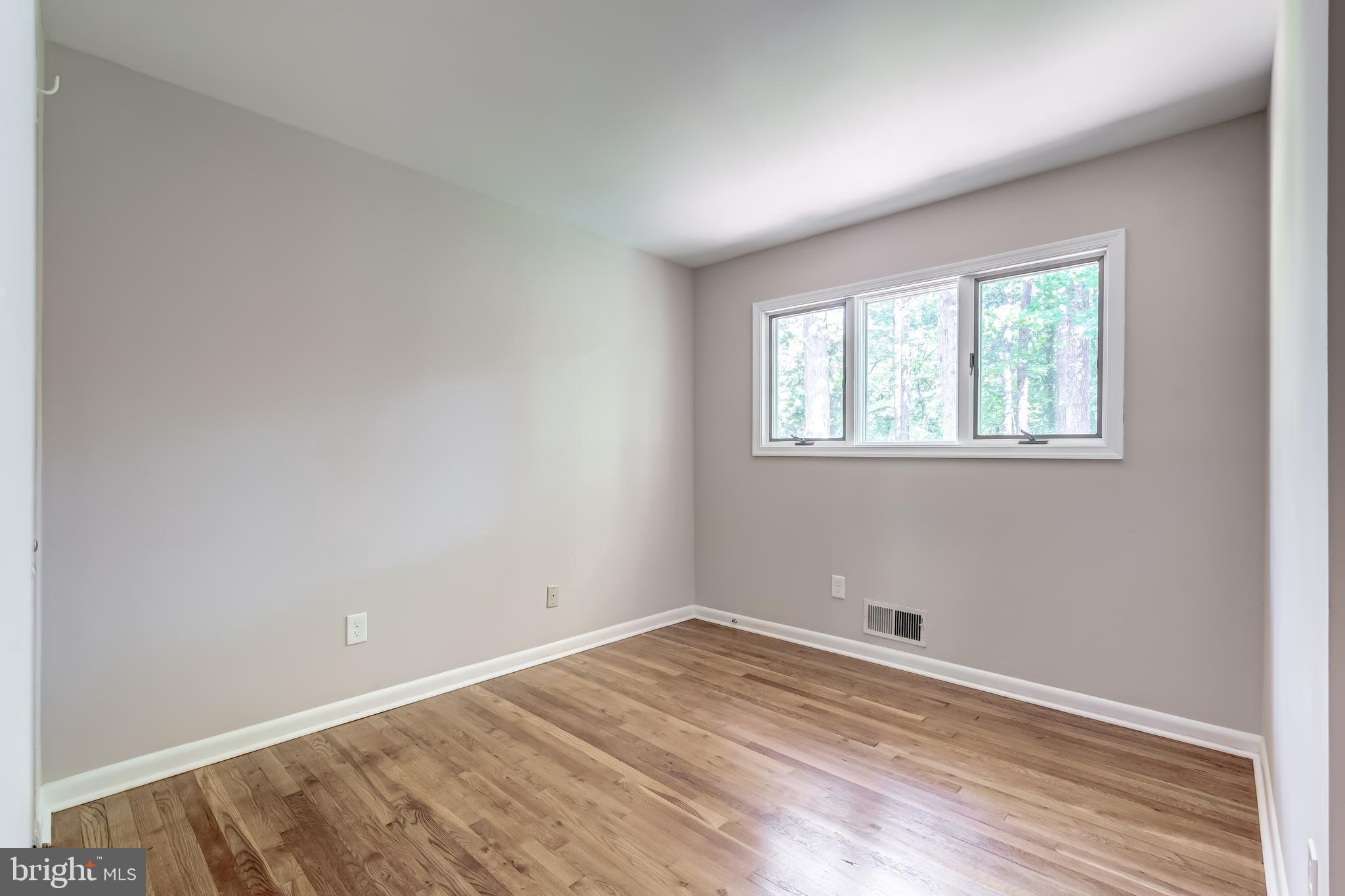 8817 Gateshead Road Alexandria, VA 22309 - Photo 44 of 78 an empty room with wooden floor and windows
