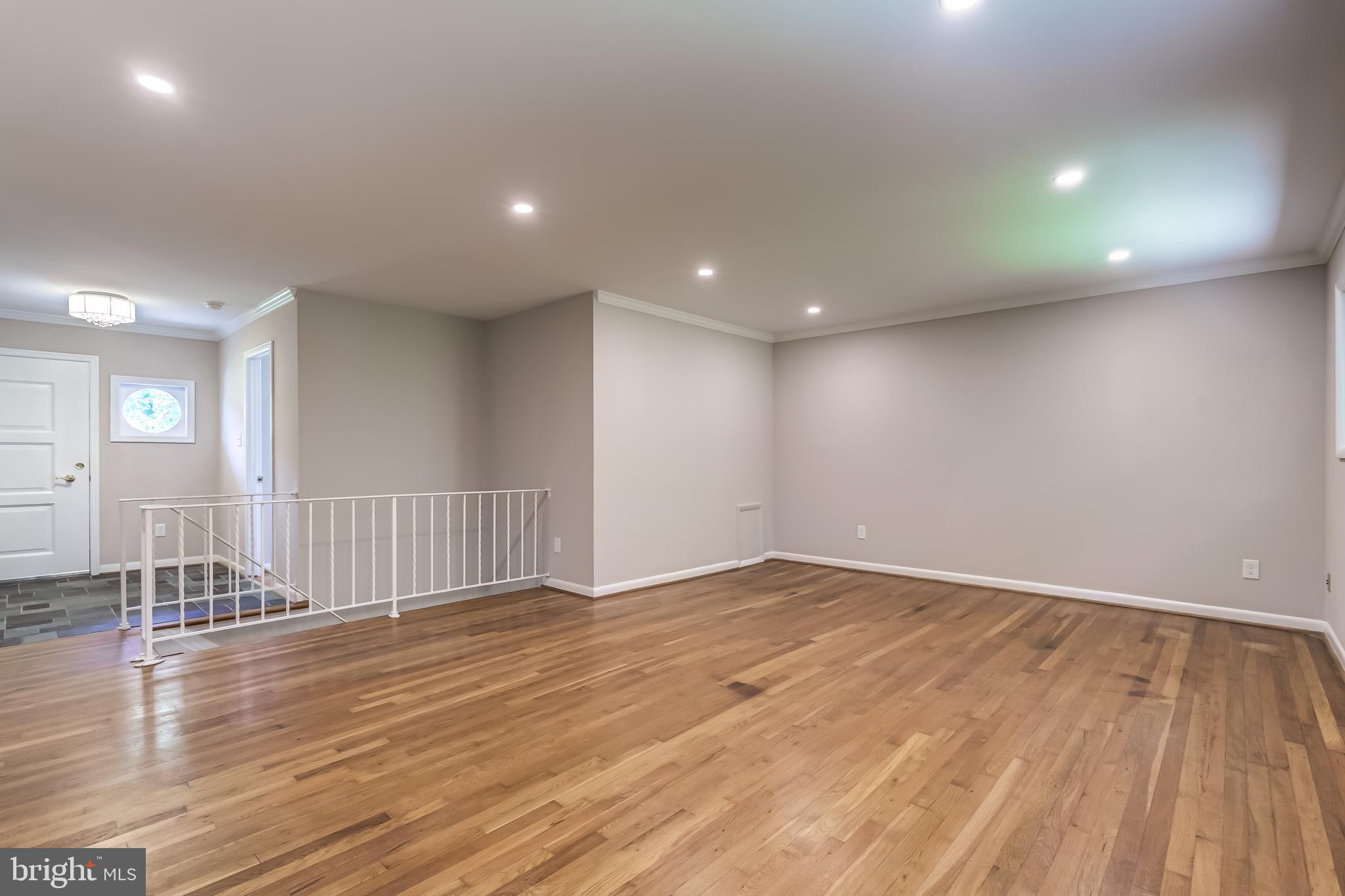8817 Gateshead Road Alexandria, VA 22309 - Photo 48 of 78 an empty room with wooden floor and windows