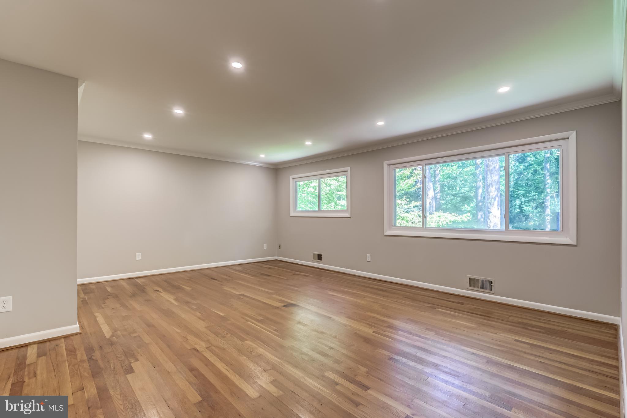 8817 Gateshead Road Alexandria, VA 22309 - Photo 49 of 78 a view of an empty room with wooden floor and a window