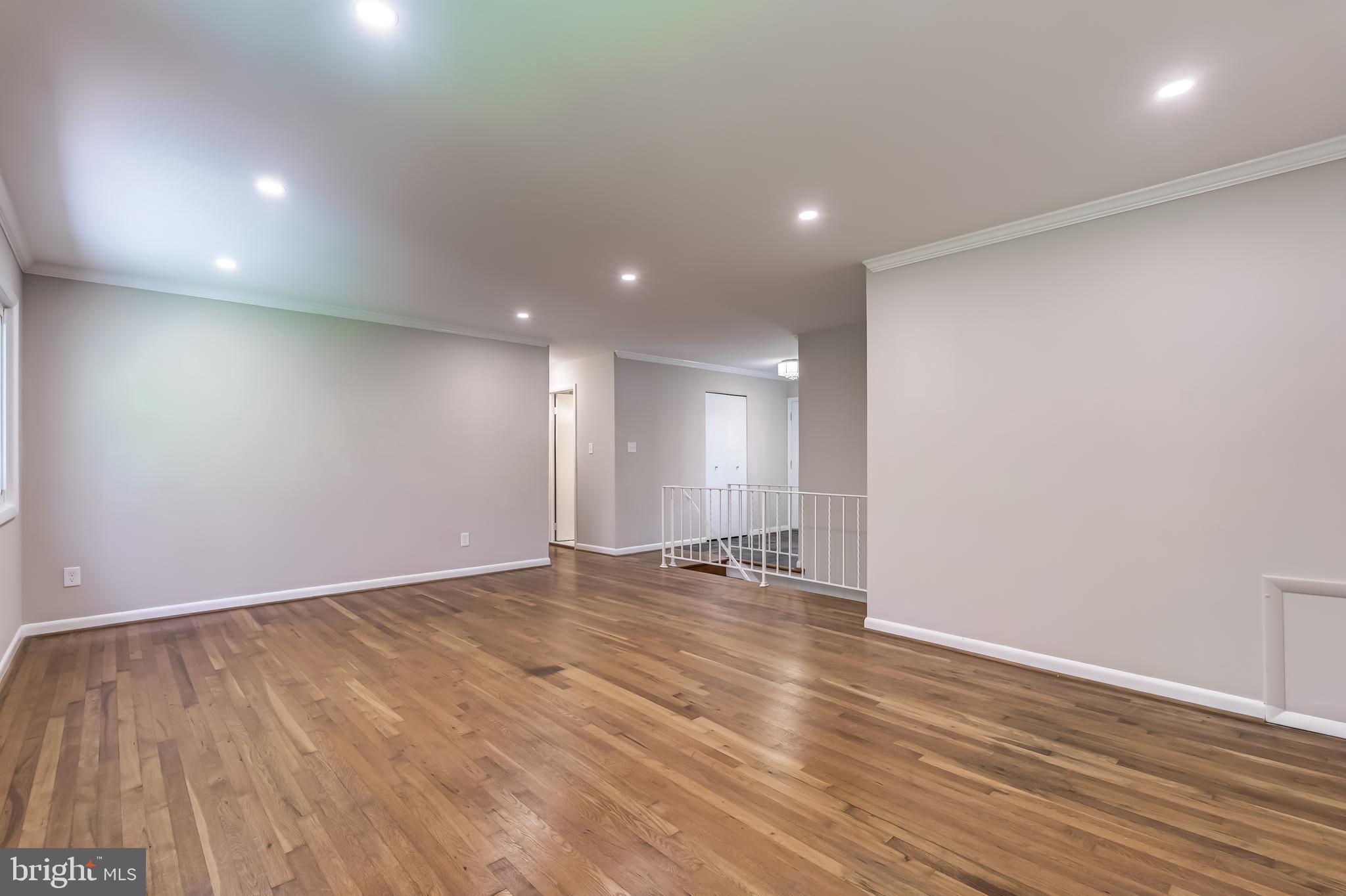 8817 Gateshead Road Alexandria, VA 22309 - Photo 50 of 78 an empty room with wooden floor and windows