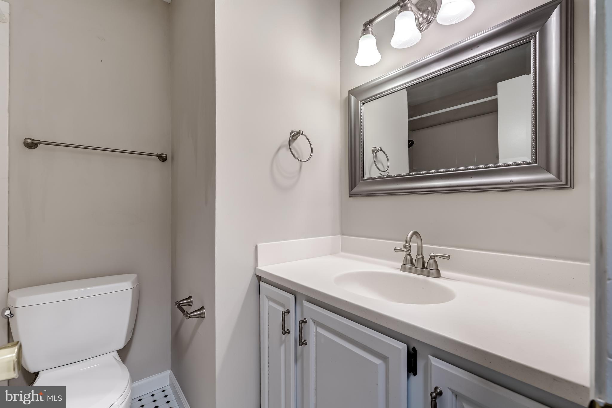 8817 Gateshead Road Alexandria, VA 22309 - Photo 52 of 78 a bathroom with a toilet a sink and mirror