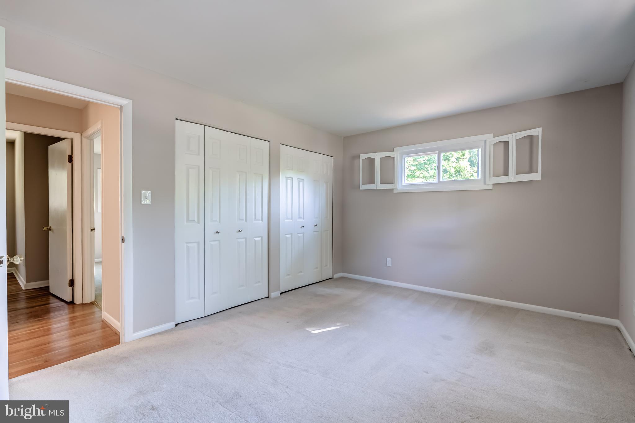 8817 Gateshead Road Alexandria, VA 22309 - Photo 56 of 78 a view of an empty room with wooden floor and a window