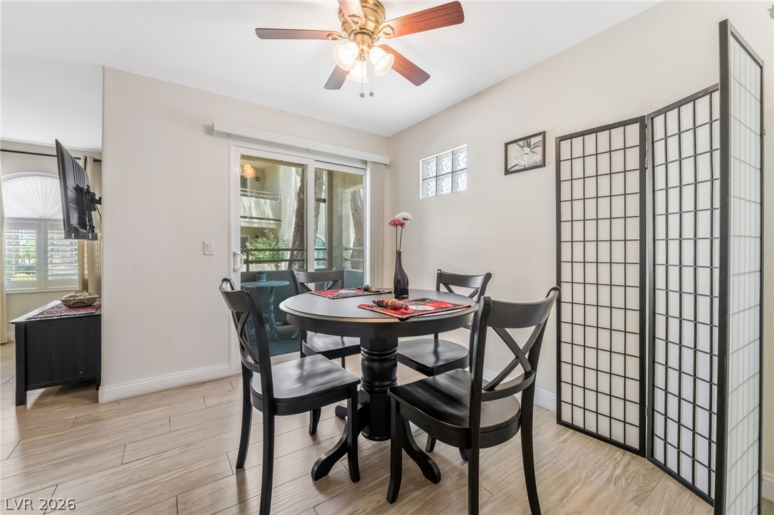 3145 East Flamingo Road, Unit 1092 Las Vegas, NV 89121 - Photo 7 of 33 Enjoy a well-lit dining area with direct balcony access and an overhead ceiling fan.