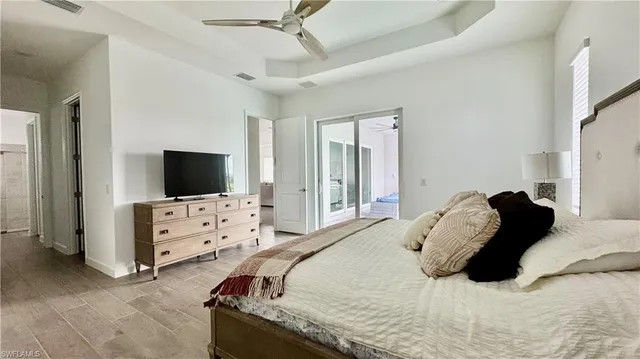 a bedroom with a bed and flat screen tv