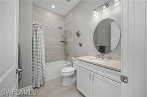 17574 Ashcomb Way Estero, FL 33928 - Photo 23 of 29 a bathroom with a granite countertop sink toilet mirror vanity and shower