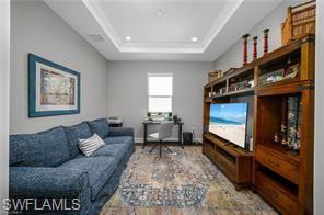 17574 Ashcomb Way Estero, FL 33928 - Photo 26 of 29 a living room with furniture and a flat screen tv