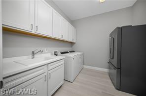 17574 Ashcomb Way Estero, FL 33928 - Photo 28 of 29 a utility room with cabinets washer and dryer