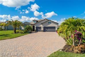 17574 Ashcomb Way Estero, FL 33928 - Photo 29 of 29 a front view of a house with a yard and potted plants