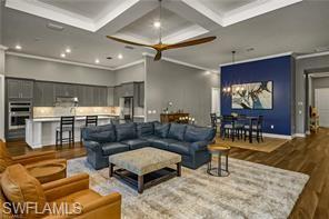 17574 Ashcomb Way Estero, FL 33928 - Photo 4 of 29 a living room with furniture and a chandelier