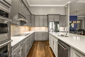 17574 Ashcomb Way Estero, FL 33928 - Photo 7 of 29 a kitchen with a sink and refrigerator