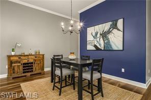 17574 Ashcomb Way Estero, FL 33928 - Photo 9 of 29 a view of a dining room with furniture and chandelier
