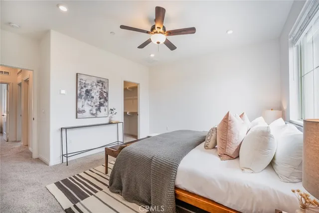 a bedroom with a large bed and a chandelier