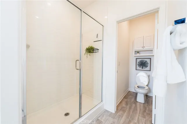 a bathroom with a shower and a toilet