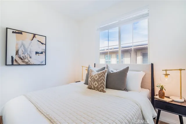 a bedroom with a bed and a painting on the wall