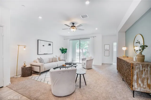 a living room with furniture a table and a chandelier