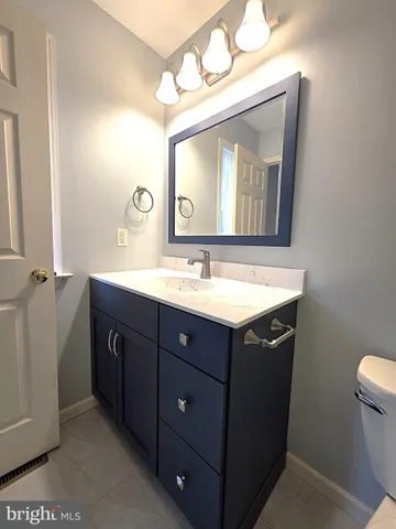 a bathroom with a sink vanity and a mirror