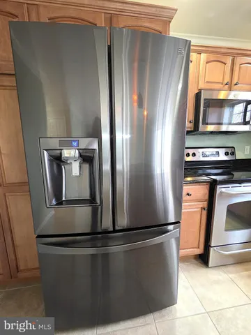 a close view of stove and refrigerator