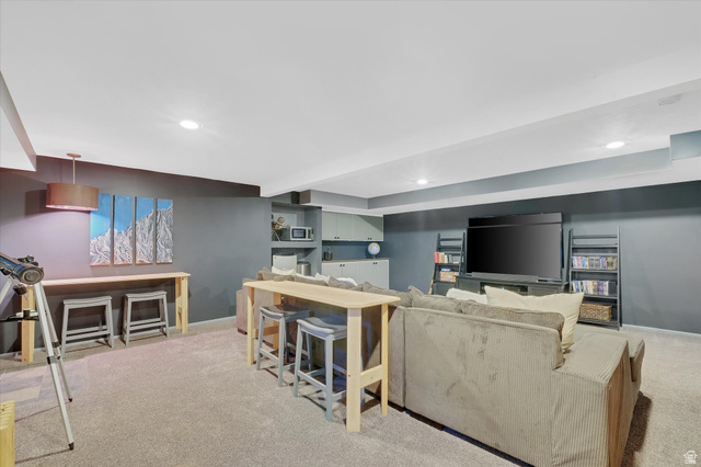 510 Spring Creek Road Providence, UT 84332 - Photo 35 of 97 Finished lower level featuring recessed lighting, plush carpeting, a built-in media center, and a dedicated bar area with cabinetry and shelving