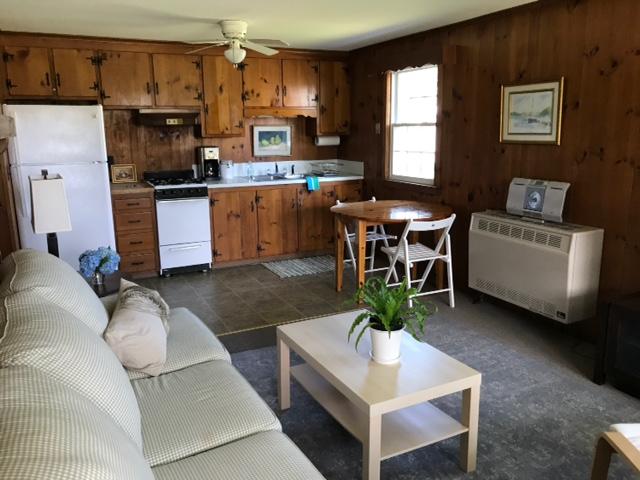 170 Beach Road Orleans, MA 02653 - Photo 4 of 10 a kitchen with a table chairs and a refrigerator