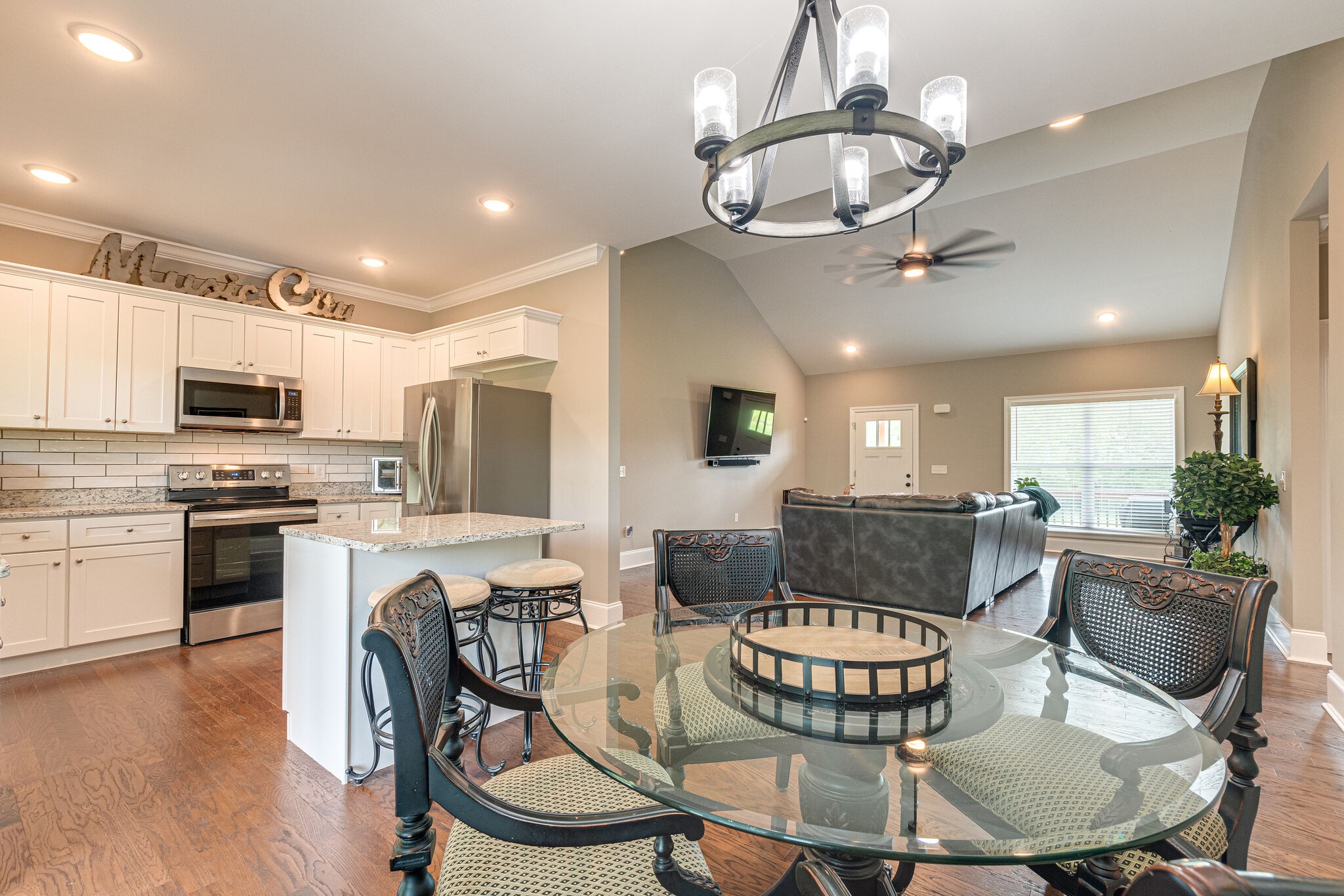 1427 Cliff Amos Road Spring Hill, TN 37174 - Photo 19 of 52 a view of a dining room with furniture a kitchen and chandelier