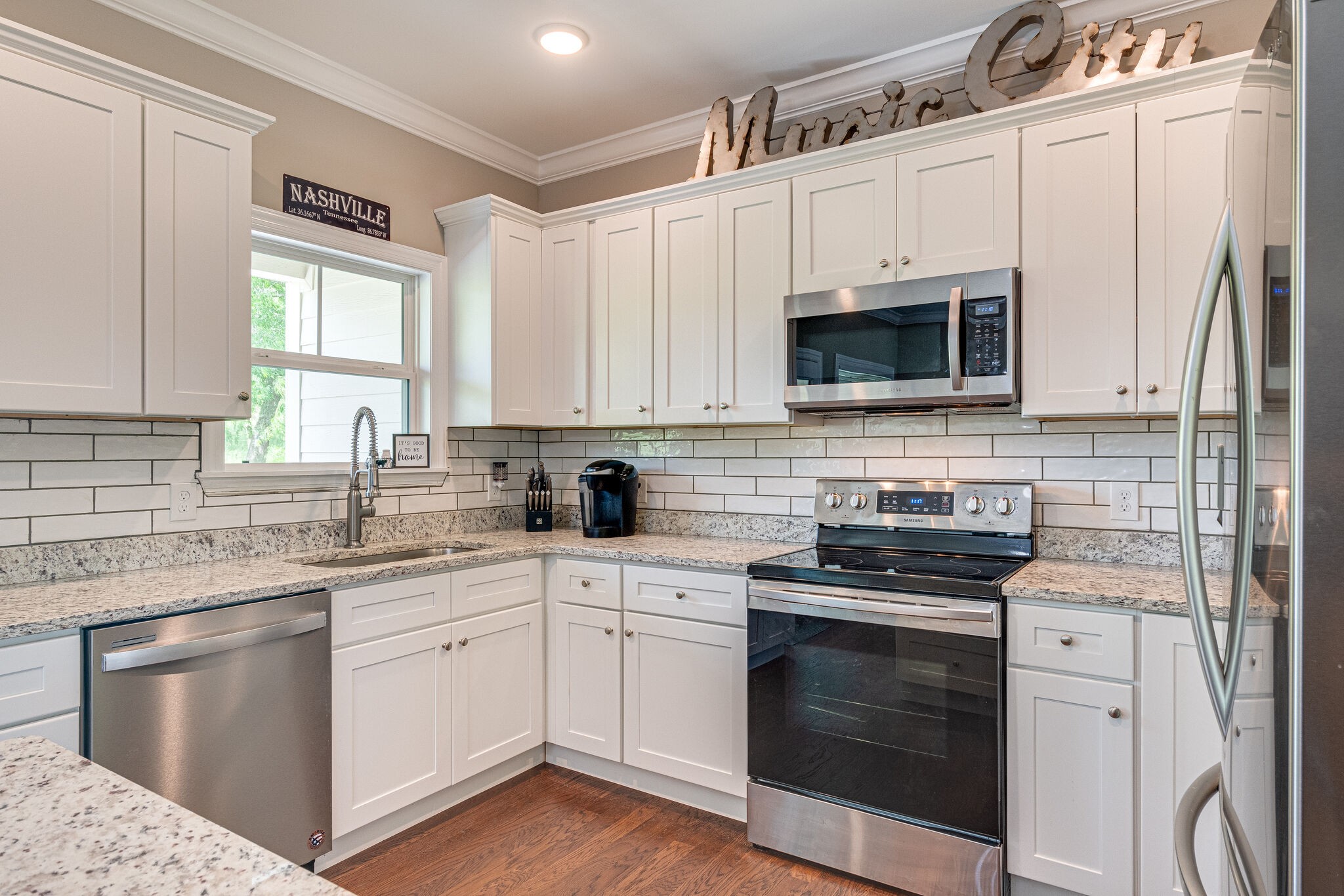 1427 Cliff Amos Road Spring Hill, TN 37174 - Photo 21 of 52 a kitchen with cabinets stainless steel appliances a sink and a window