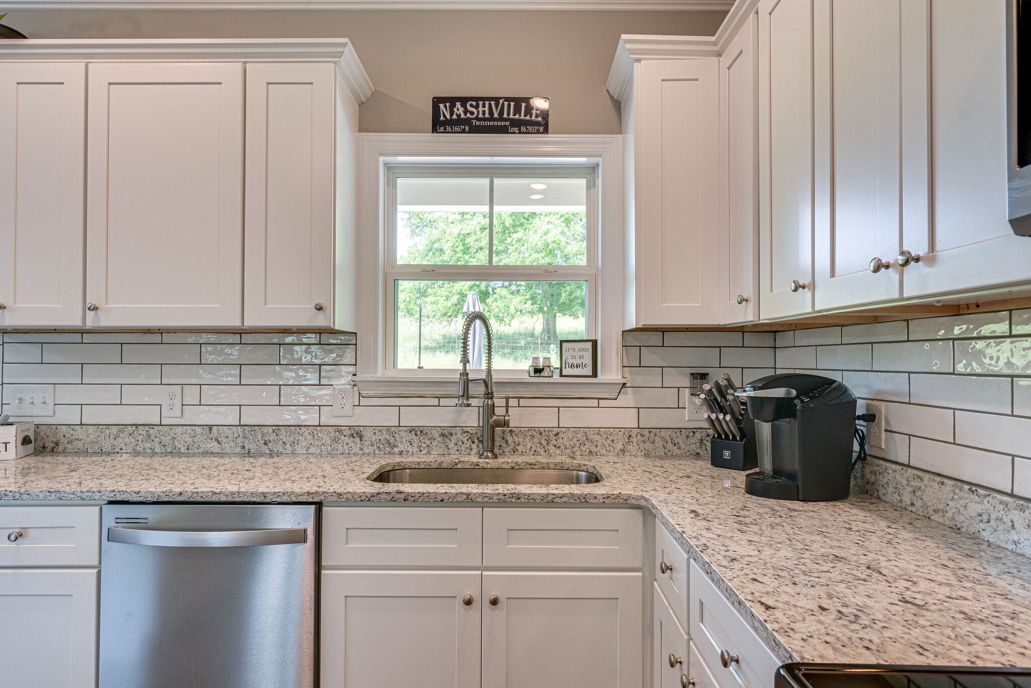 1427 Cliff Amos Road Spring Hill, TN 37174 - Photo 22 of 52 a kitchen with stainless steel appliances granite countertop a sink stove and cabinets