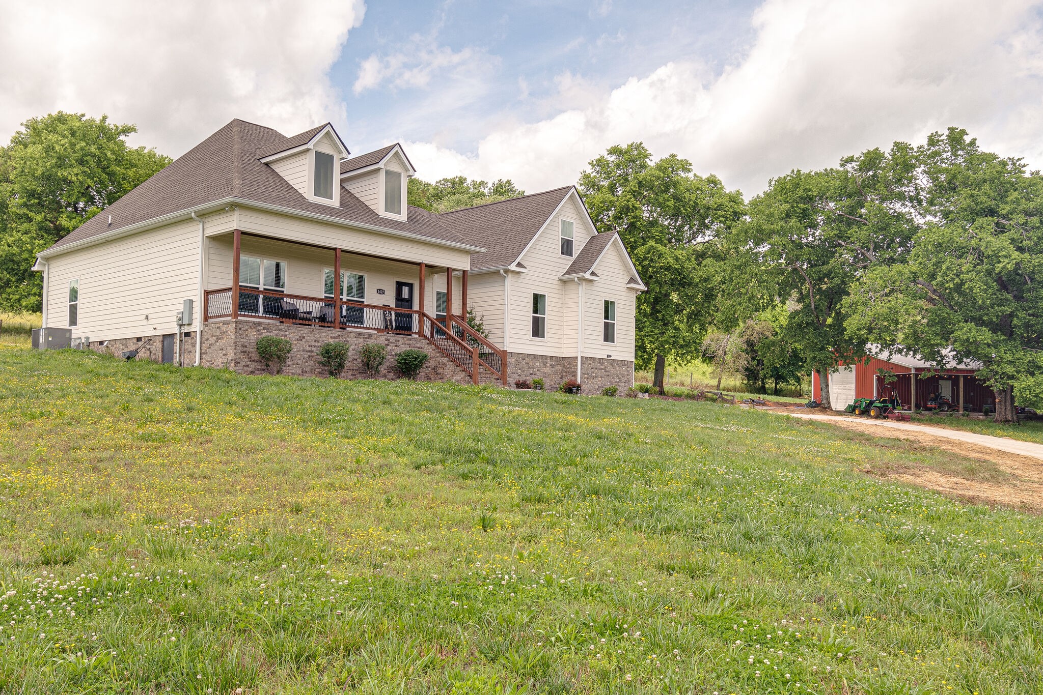 1427 Cliff Amos Road Spring Hill, TN 37174 - Photo 7 of 52 a view of a house with a big yard and large trees