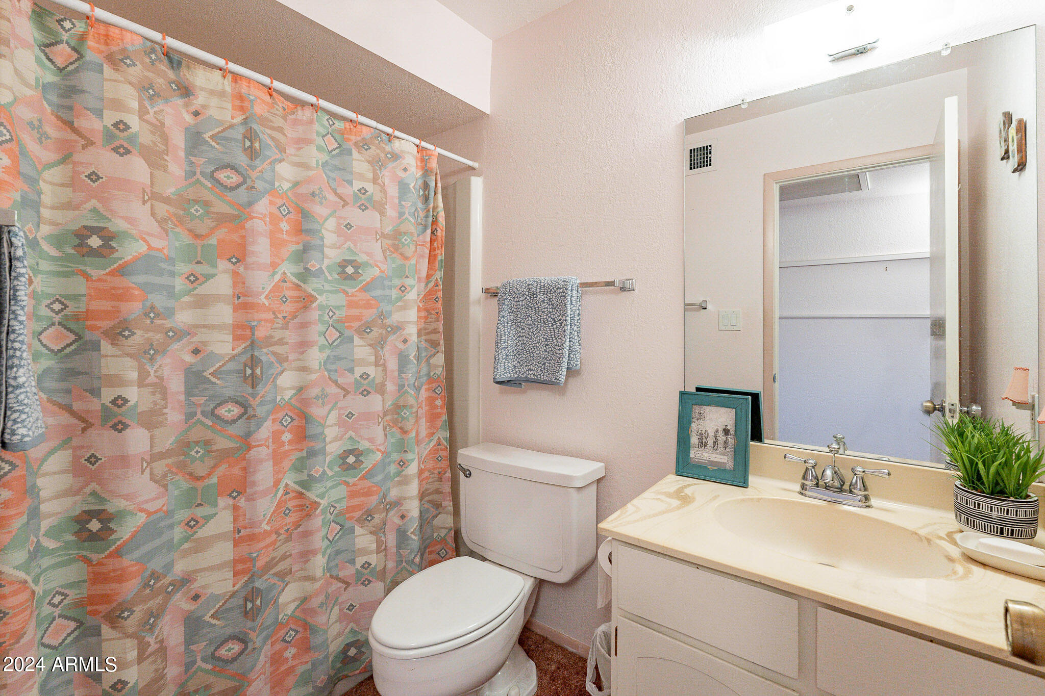 5138 North 81st Street Scottsdale, AZ 85250 - Photo 20 of 40 a bathroom with a sink a toilet and shower curtain