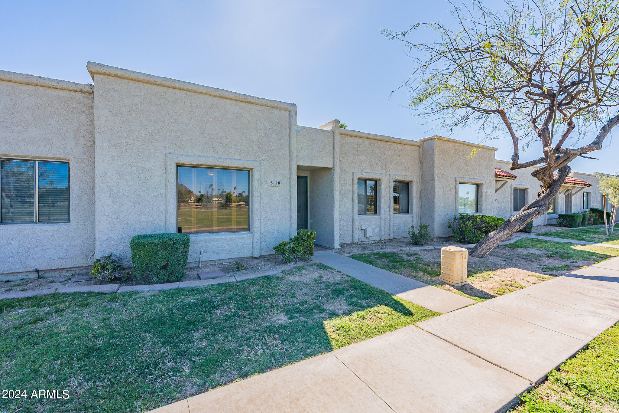 5138 North 81st Street Scottsdale, AZ 85250 - Photo 2 of 40 a view of a brick house with a yard and large tree