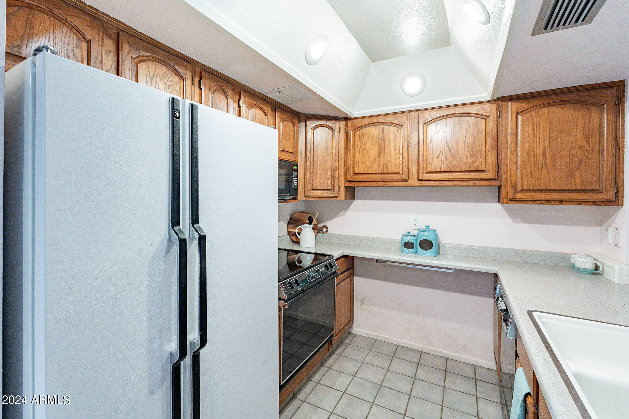 5138 North 81st Street Scottsdale, AZ 85250 - Photo 6 of 40 a kitchen with a refrigerator a sink and cabinets